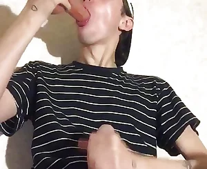 A youthfull cherry gargles a fuck stick and drains off his bone until he spunks on his T-shirt